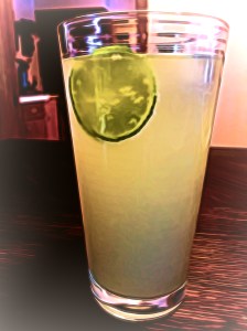 A glass of homemade ginger beer with a slice of fresh lime
